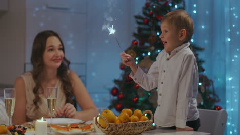 Large-happy-family-celebrating-new-year.-Cheerful-family-members-of-different-generations-holding-sparklers-and-smiling.-celebrating-christmas-dinner.-High-quality-4k-footage